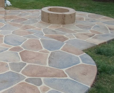 One of a kind stamped patio with a concrete fire place in the middle in Kalamazoo, Michigan.