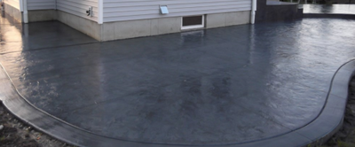 Dark gray stamped concrete along side of home in Portage, Michigan.