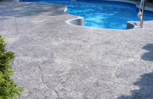 Pool deck in Portage, Michigan with a stamped concrete design.