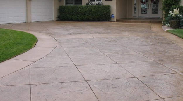 Stained concrete driveway with a reddish brown color in Portage, Michigan.