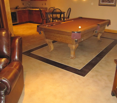 Basement concrete floors with a billiards table.