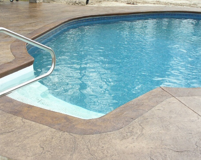 Pool in Kalamazoo, Michigan with steps and concrete stamped deck.