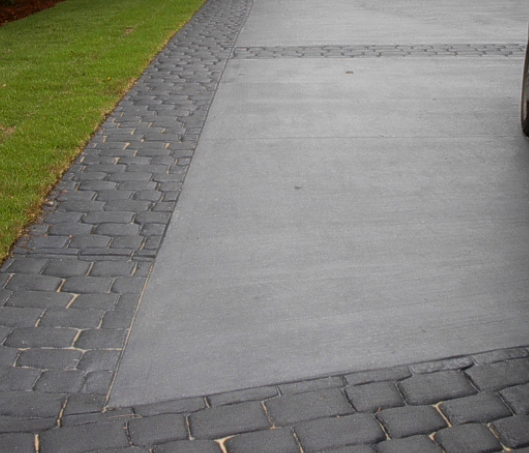 Concrete driveway with a stamped cobblestone edging around whole driveway.