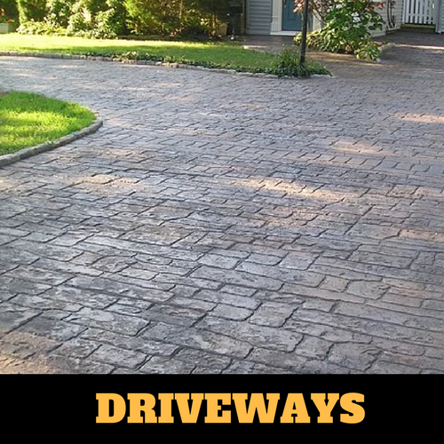 Two toned colored concrete driveway in Portage, Michigan with brick home.